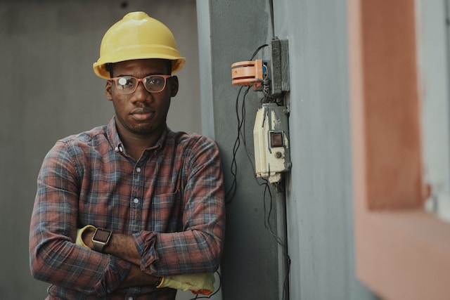 electrician next to fuse box