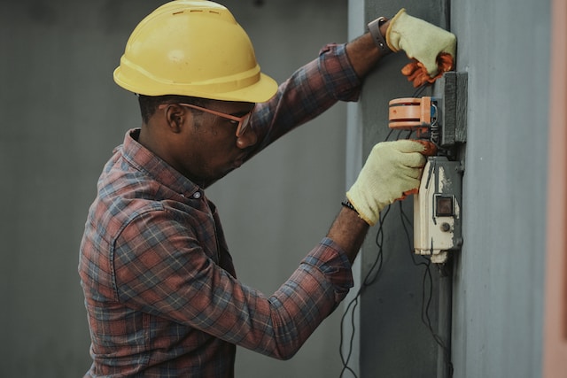electrician working on a fuse box