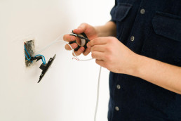 person wiring a plug