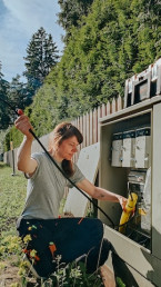 Female electrical tradesperson servicing a fuse box